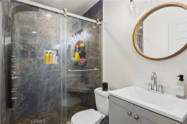 a bathroom with a sink toilet and shower