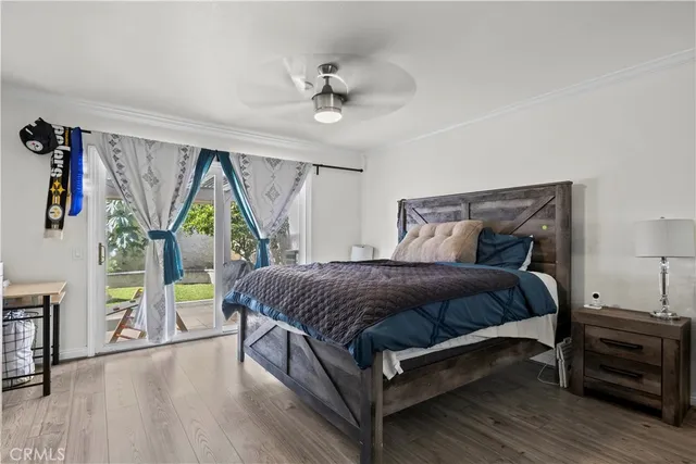 a bedroom with a bed a couch and a window