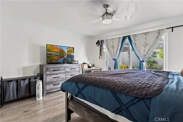a bedroom with a bed window and a flat screen tv