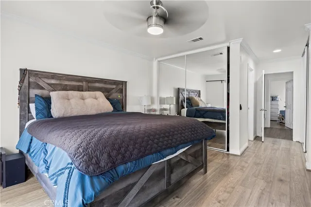 a bedroom with a large bed and a chandelier