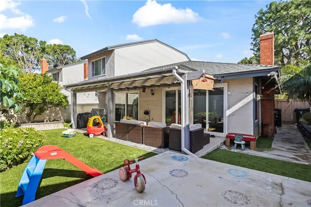 a view of a house with backyard sitting area and garden