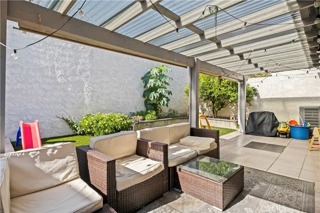 a living room with furniture and a potted plant