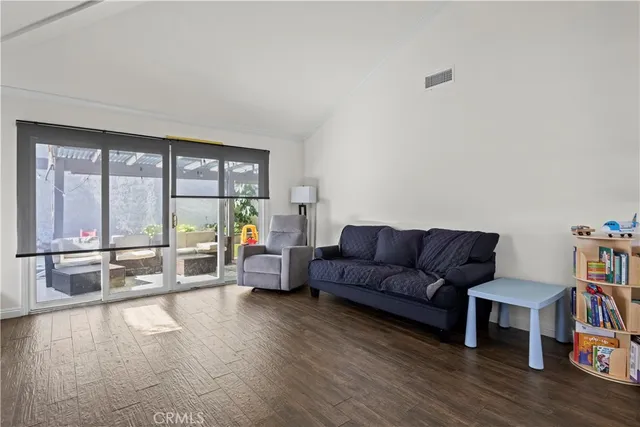 a living room with furniture and a floor to ceiling window