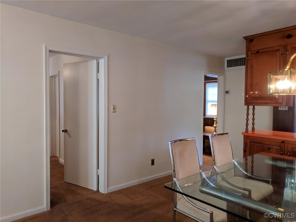 3410 Stuart Avenue Richmond, VA 23221 - Photo 7 of 43 a view of a dining room with furniture and chandelier
