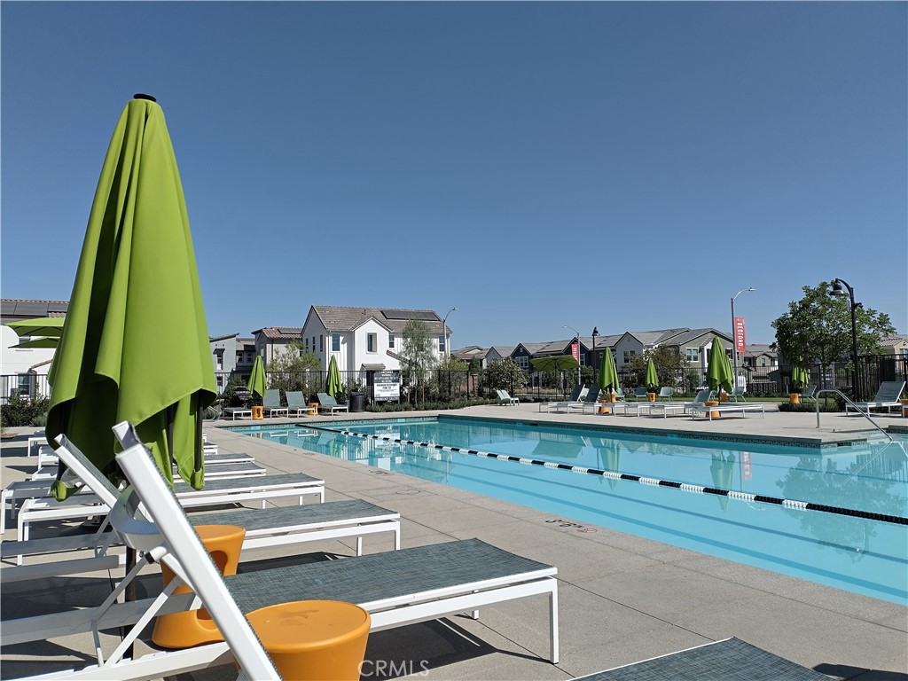 2600 Sprout Lane Corona, CA 92883 - Photo 16 of 30 a view of a swimming pool with a bench and trees in the background