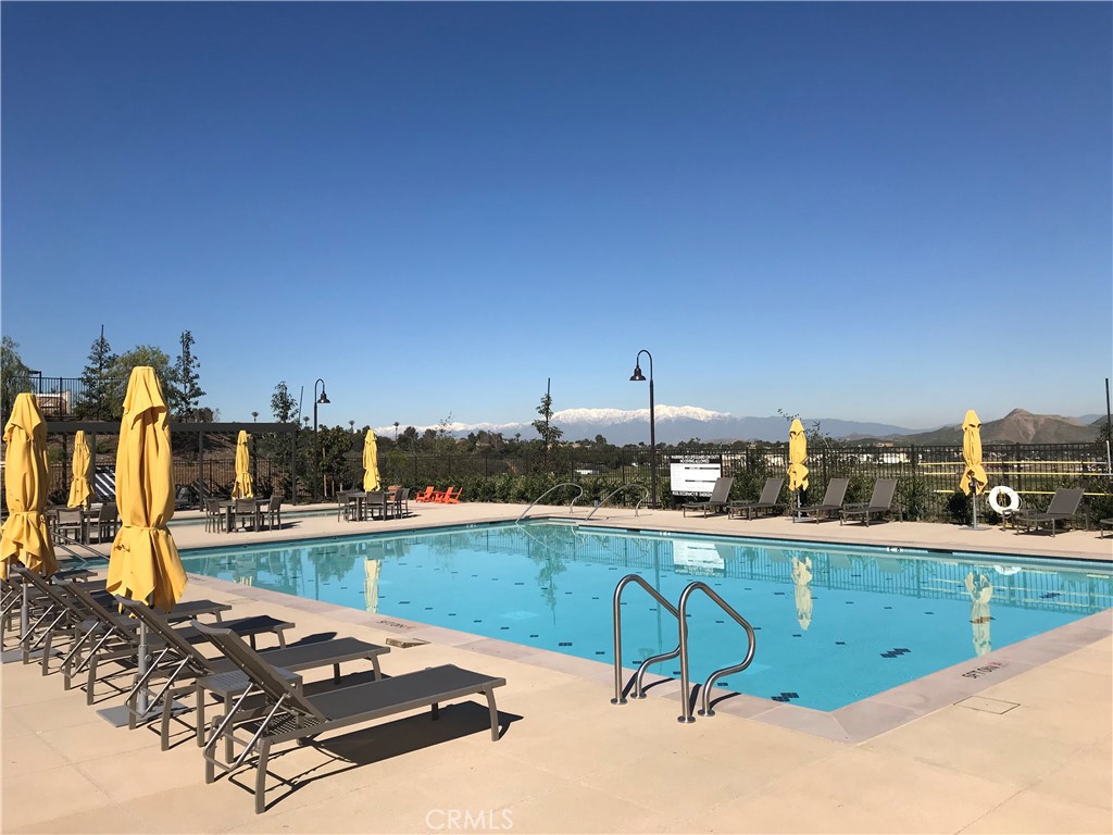 2600 Sprout Lane Corona, CA 92883 - Photo 28 of 30 a view of a swimming pool with a bench and lawn chairs