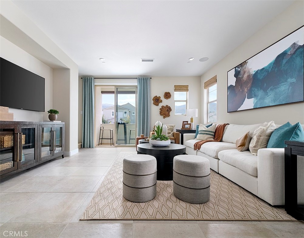2600 Sprout Lane Corona, CA 92883 - Photo 9 of 30 a living room with furniture a flat screen tv and large windows