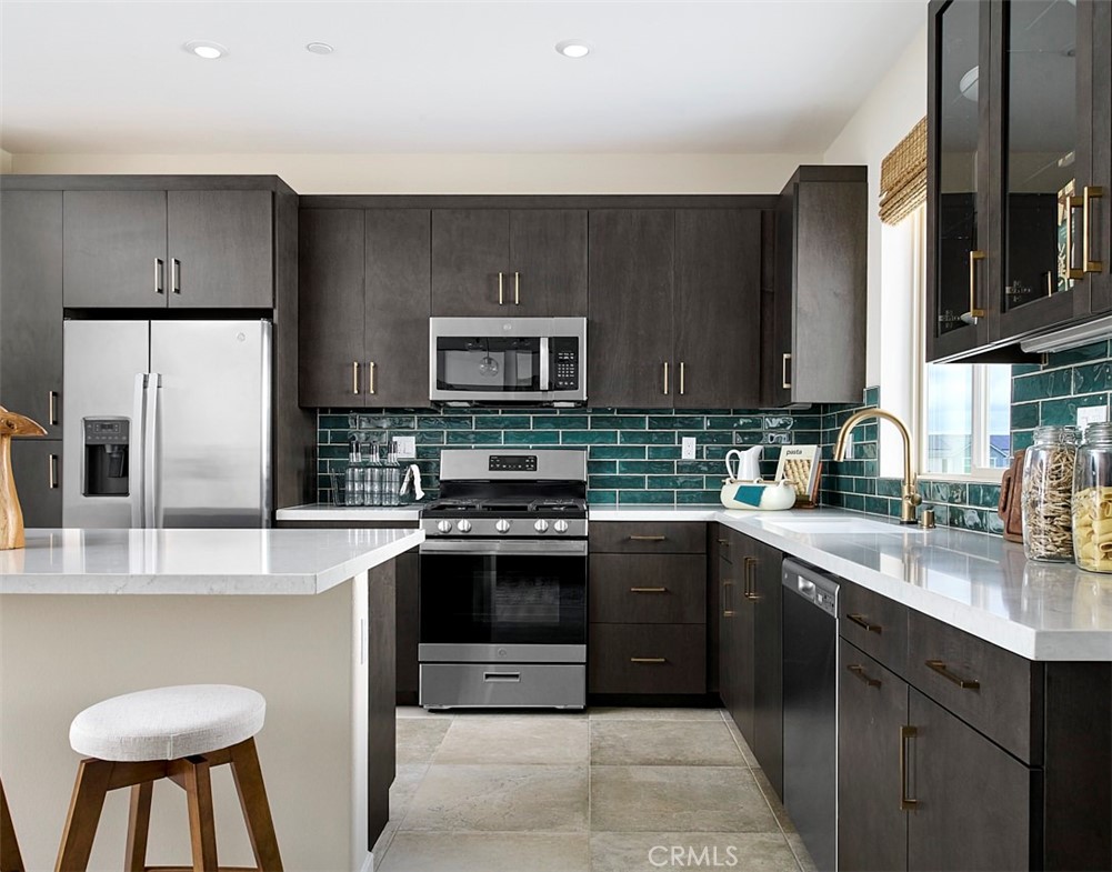2600 Sprout Lane Corona, CA 92883 - Photo 10 of 30 a kitchen with stainless steel appliances granite countertop a sink stove and refrigerator