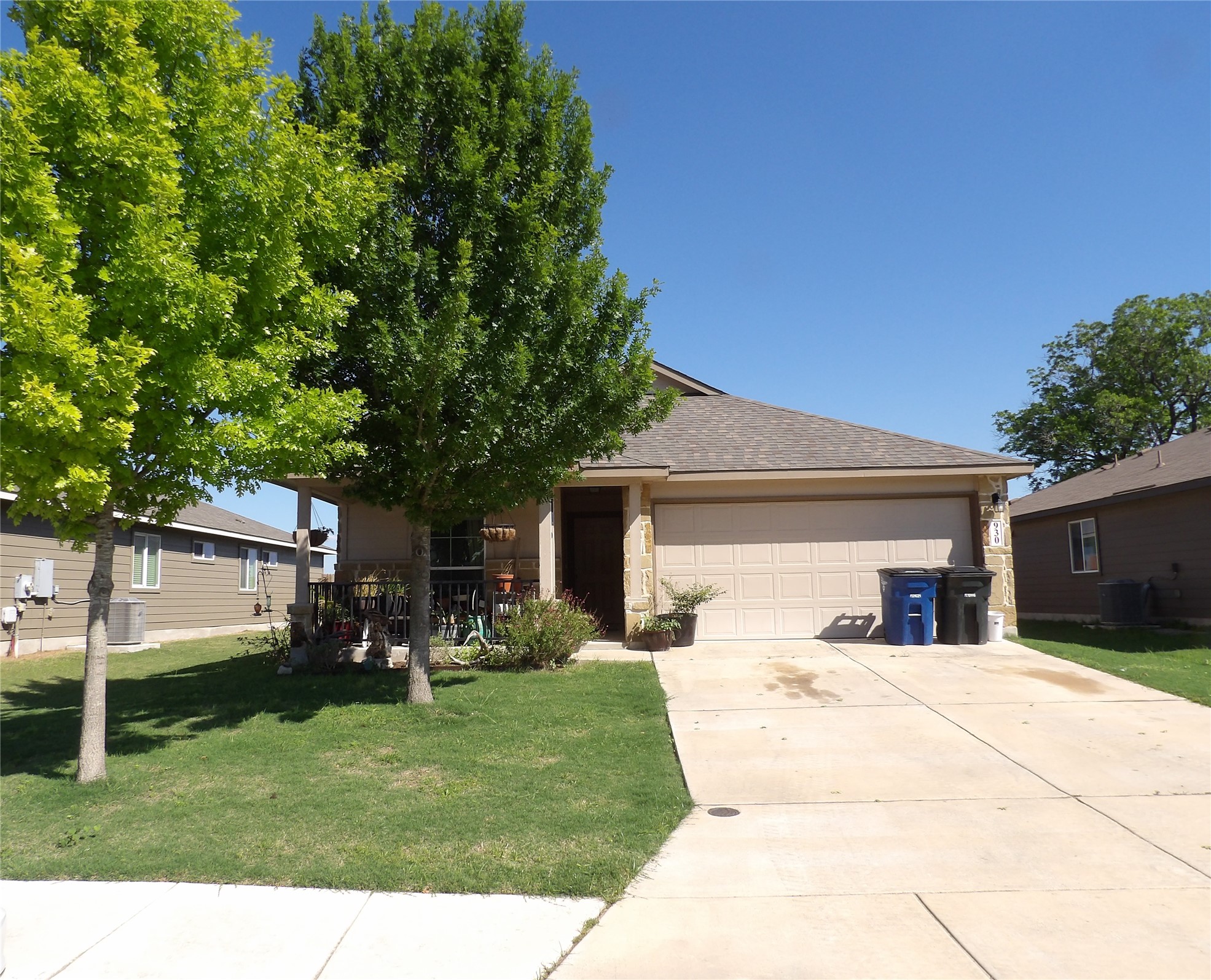 930 Pumpkin Ridge New Braunfels, TX 78130 - Photo 1 of 32 Single-story residence featuring a covered front porch, an attached two-car garage, and a concrete driveway
