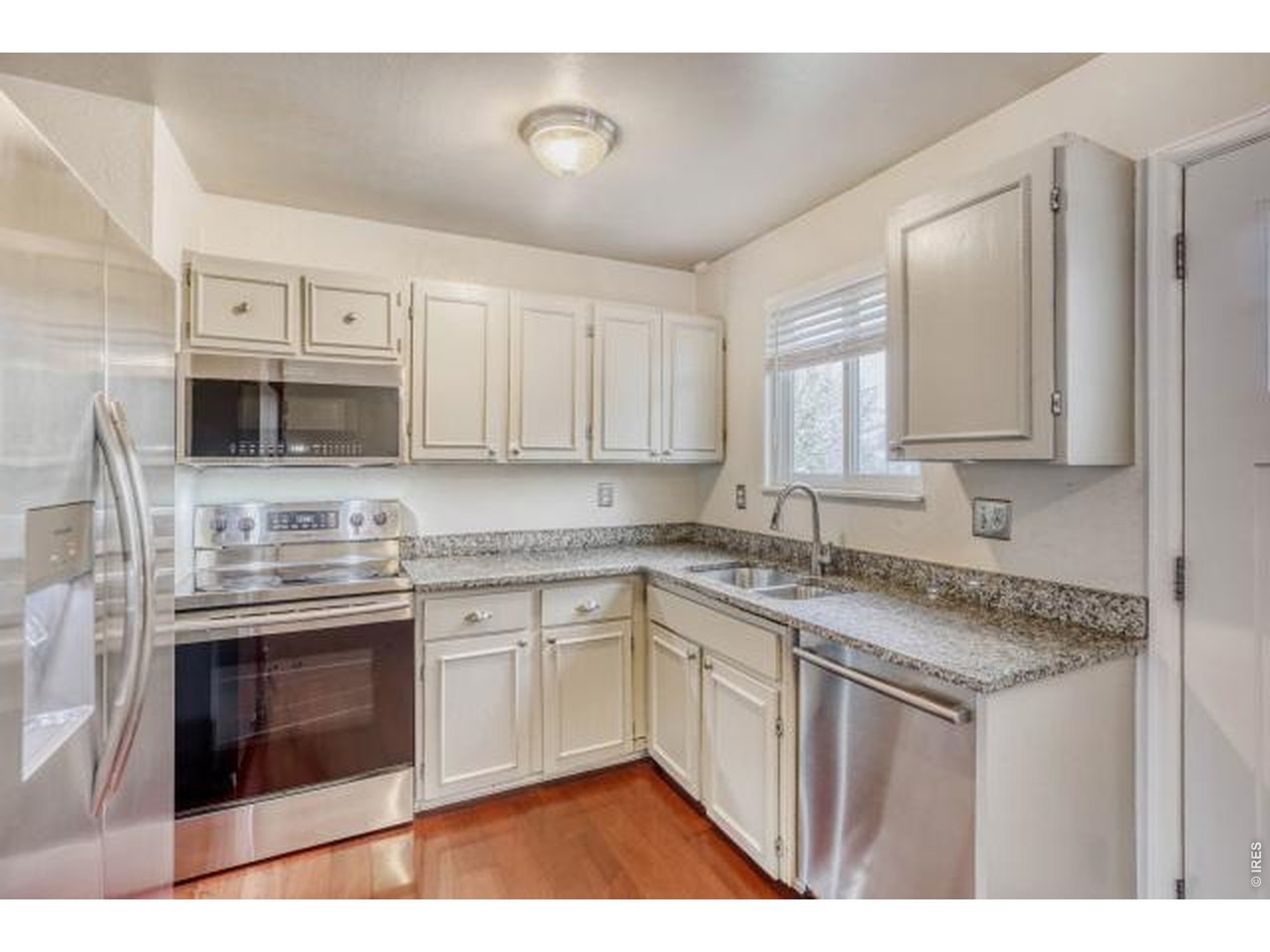 10748 Routt Street Broomfield, CO 80021 - Photo 4 of 30 a kitchen with stainless steel appliances granite countertop a sink and stove top oven