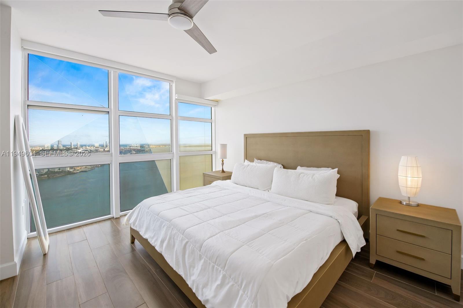 50 Biscayne Boulevard, Unit 3904 Miami, FL 33132 - Photo 12 of 21 a bedroom with a bed and a window
