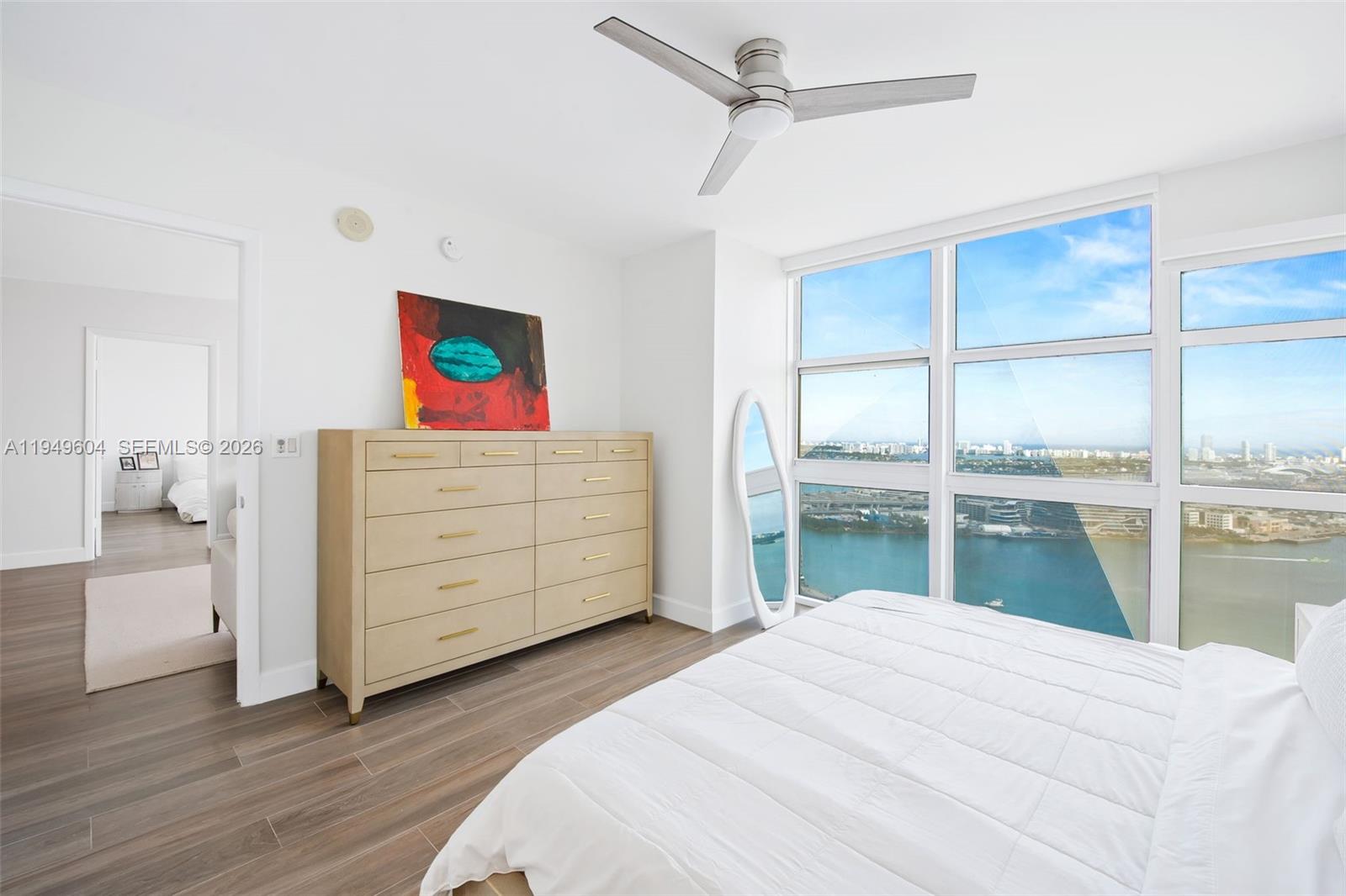 50 Biscayne Boulevard, Unit 3904 Miami, FL 33132 - Photo 13 of 21 a bedroom with a bed and a dresser