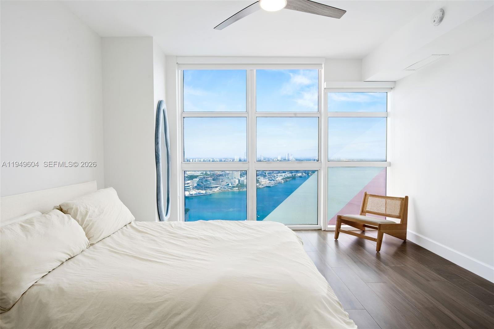 50 Biscayne Boulevard, Unit 3904 Miami, FL 33132 - Photo 17 of 21 a bedroom with a bed and a window