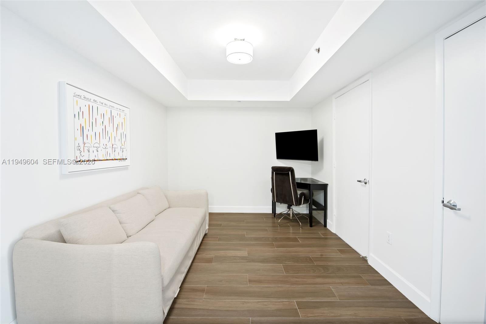 50 Biscayne Boulevard, Unit 3904 Miami, FL 33132 - Photo 20 of 21 a living room with furniture and a flat screen tv