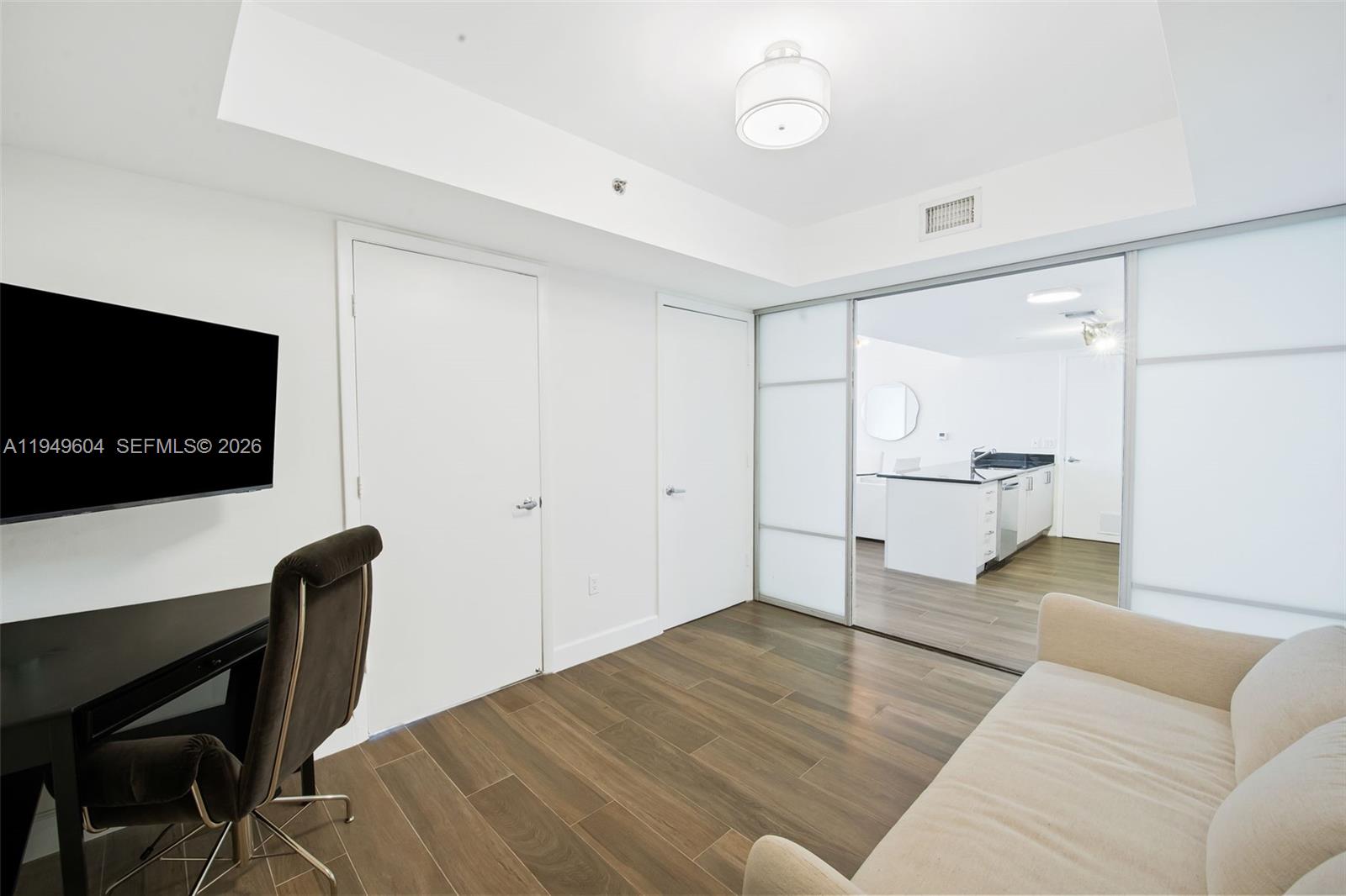 50 Biscayne Boulevard, Unit 3904 Miami, FL 33132 - Photo 21 of 21 a living room with furniture and a flat screen tv