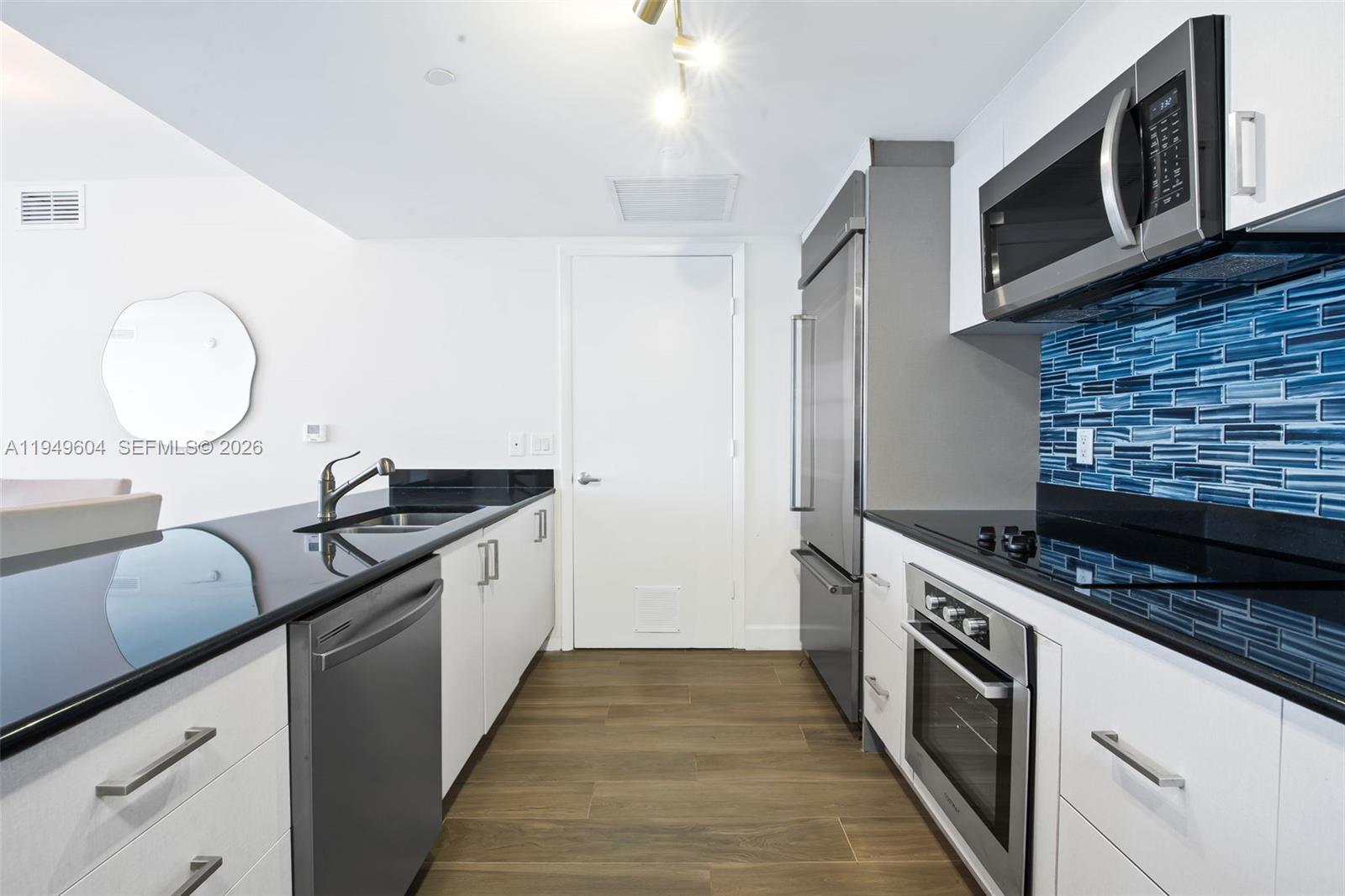 50 Biscayne Boulevard, Unit 3904 Miami, FL 33132 - Photo 4 of 21 a kitchen with stainless steel appliances granite countertop a stove and a sink