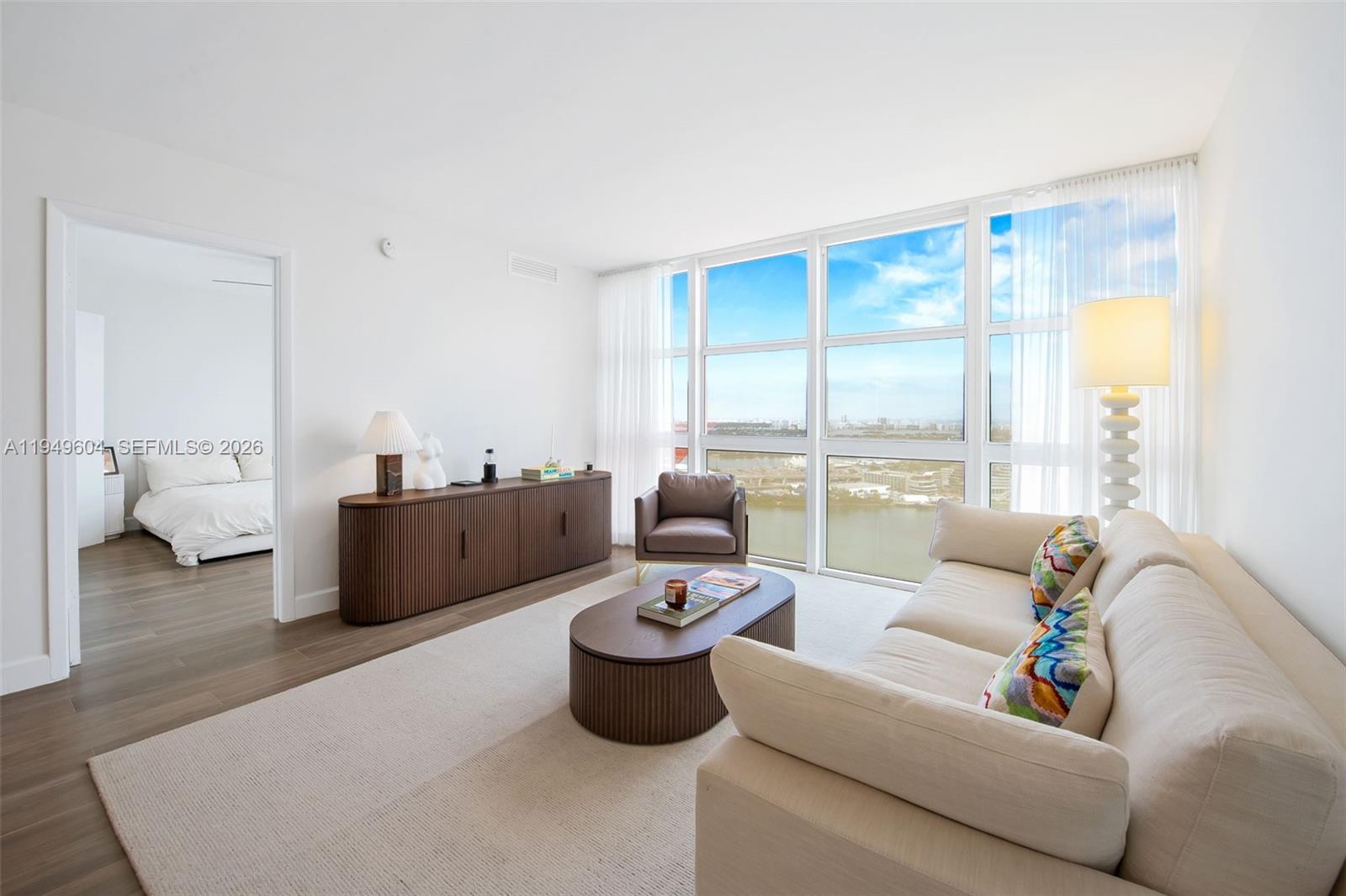 50 Biscayne Boulevard, Unit 3904 Miami, FL 33132 - Photo 8 of 21 a living room with furniture and a large window