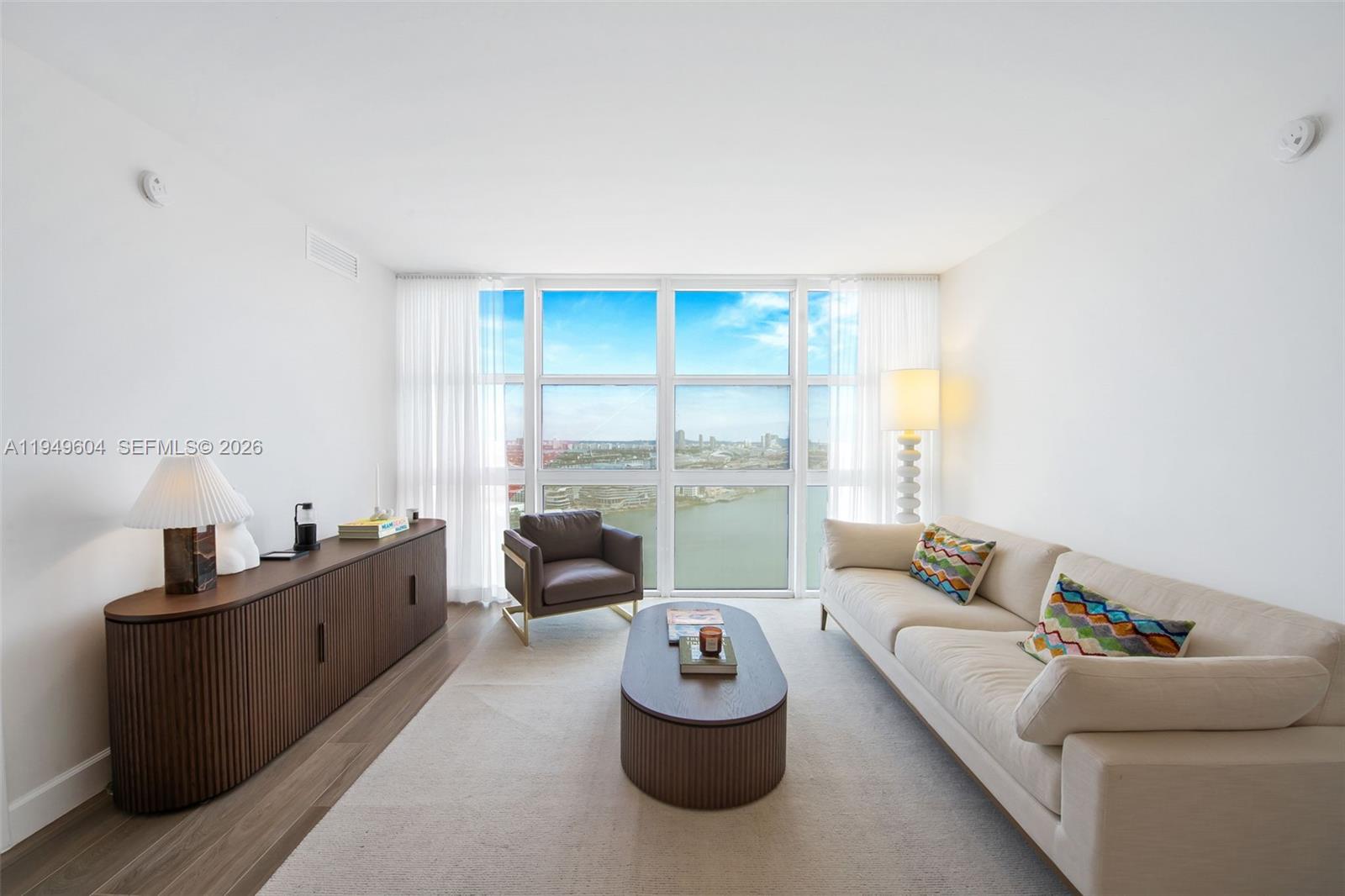 50 Biscayne Boulevard, Unit 3904 Miami, FL 33132 - Photo 9 of 21 a living room with furniture and a large window