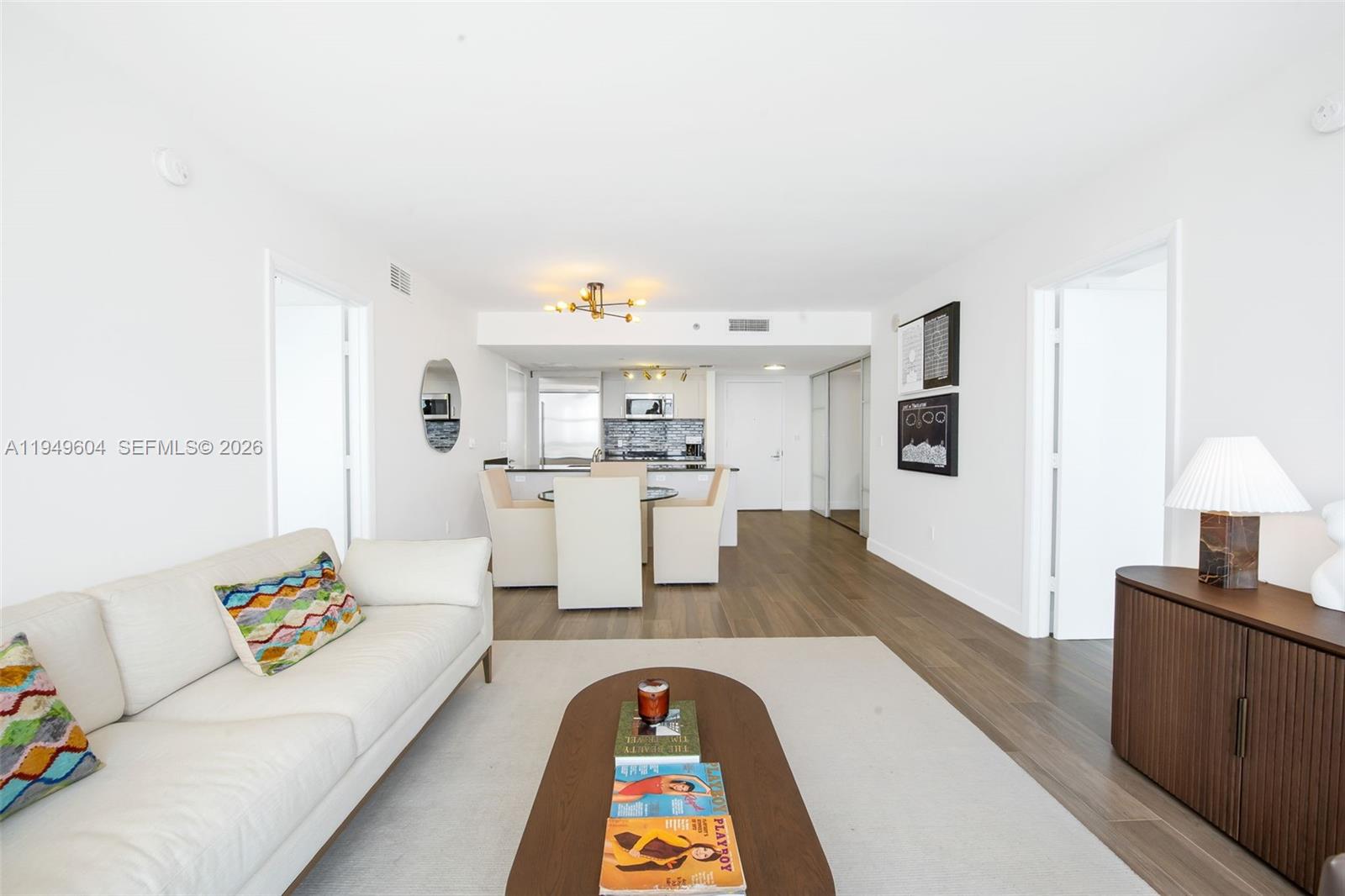 50 Biscayne Boulevard, Unit 3904 Miami, FL 33132 - Photo 10 of 21 a living room with kitchen island furniture and a kitchen view