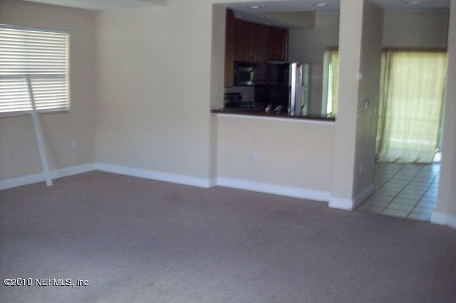9745 Touchton Road, Unit 1701 Jacksonville, FL 32246 - Photo 4 of 12 an empty room with windows