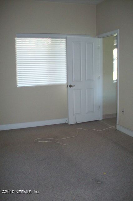 9745 Touchton Road, Unit 1701 Jacksonville, FL 32246 - Photo 6 of 12 an empty room with windows