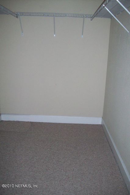 9745 Touchton Road, Unit 1701 Jacksonville, FL 32246 - Photo 7 of 12 a view of a room with racks on the wall