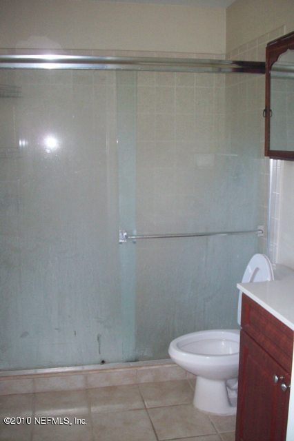 9745 Touchton Road, Unit 1701 Jacksonville, FL 32246 - Photo 8 of 12 a white toilet sitting next to a bathroom sink