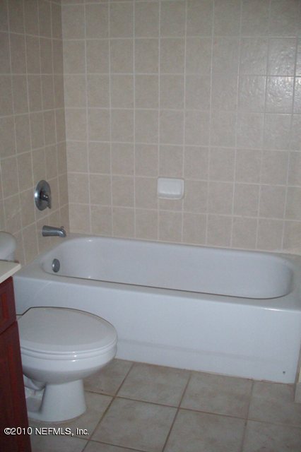 9745 Touchton Road, Unit 1701 Jacksonville, FL 32246 - Photo 10 of 12 a bathroom with a toilet and a bathtub