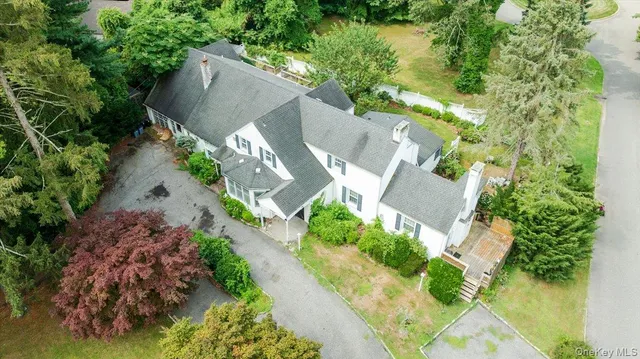 an aerial view of a house with a yard and garden