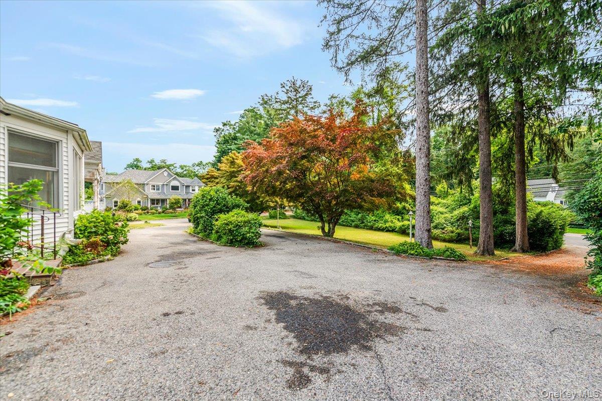 221 Huntington Bay Road Huntington, NY 11743 - Photo 20 of 23 a view of a road with a house in the background