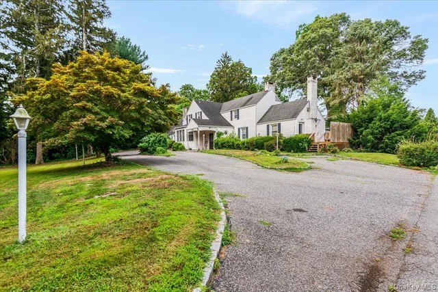a house with huge green field in front of it