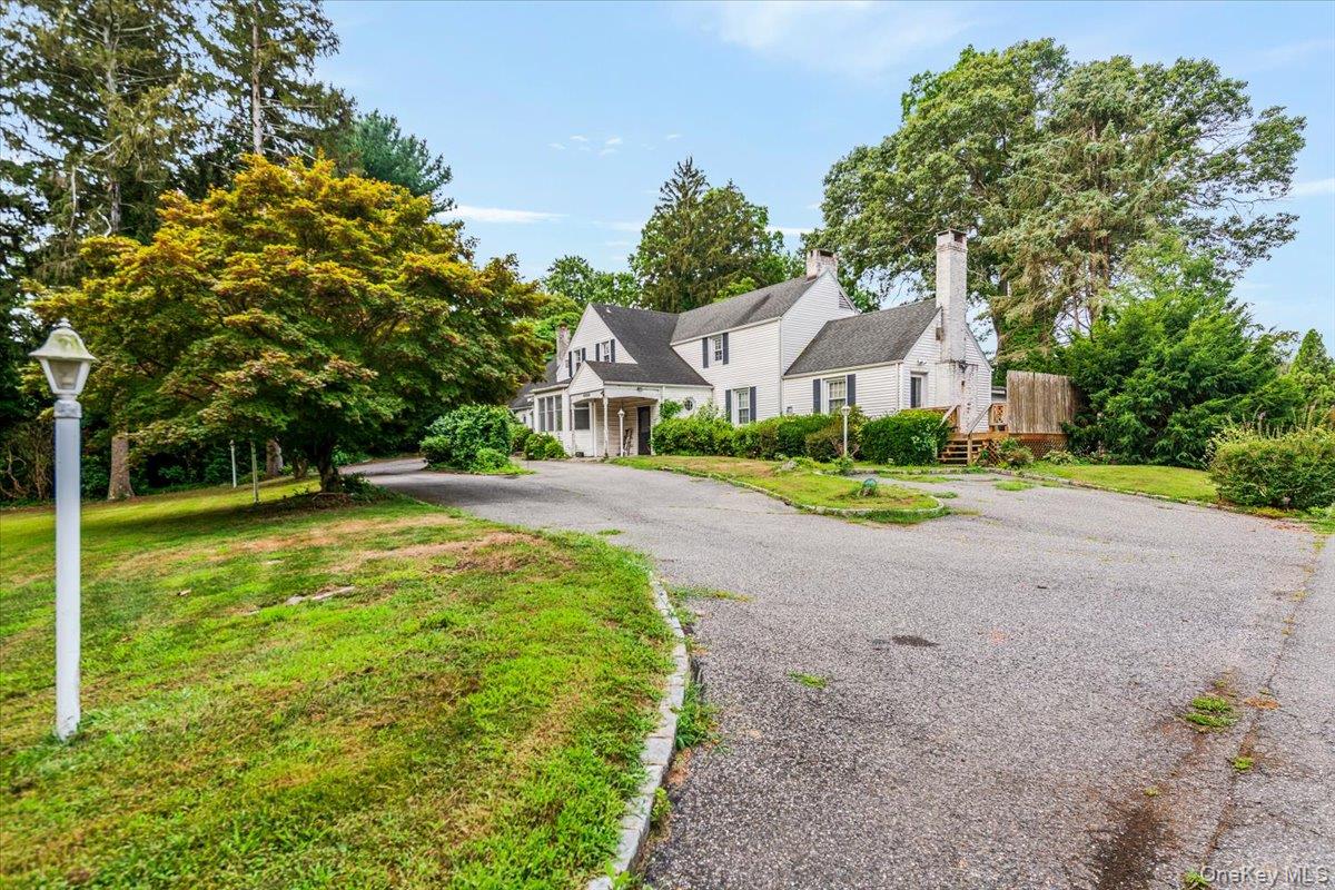 221 Huntington Bay Road Huntington, NY 11743 - Photo 2 of 23 a house with huge green field in front of it