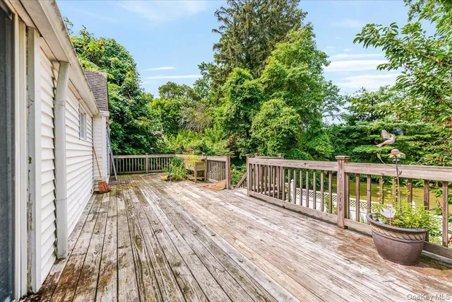 a balcony with wooden floor and fence