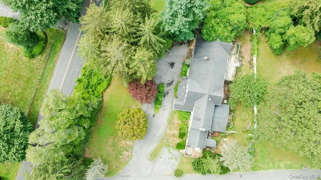 an aerial view of residential house with stairs and trees all around