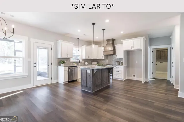 a bathroom with a granite countertop sink a mirror and a shower