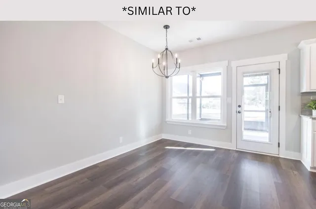 a bathroom with a granite countertop sink a toilet and a mirror