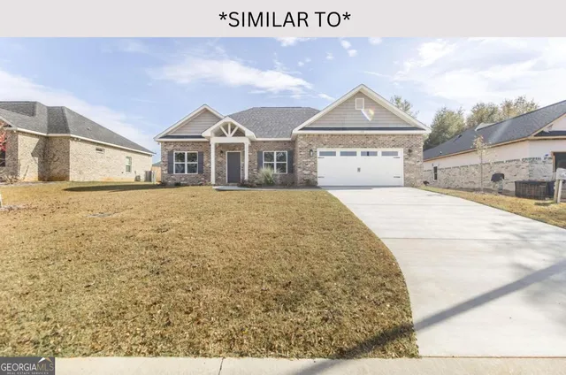 a large kitchen with a center island wooden floor stainless steel appliances and windows