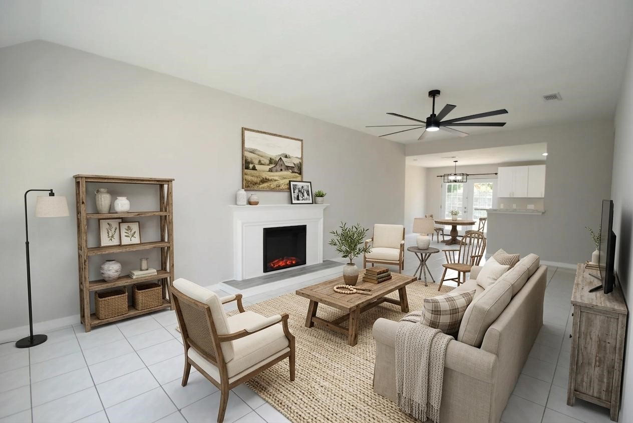 22831 John Rolfe Lane Katy, TX 77449 - Photo 9 of 34 a living room with furniture a fireplace and a flat screen tv