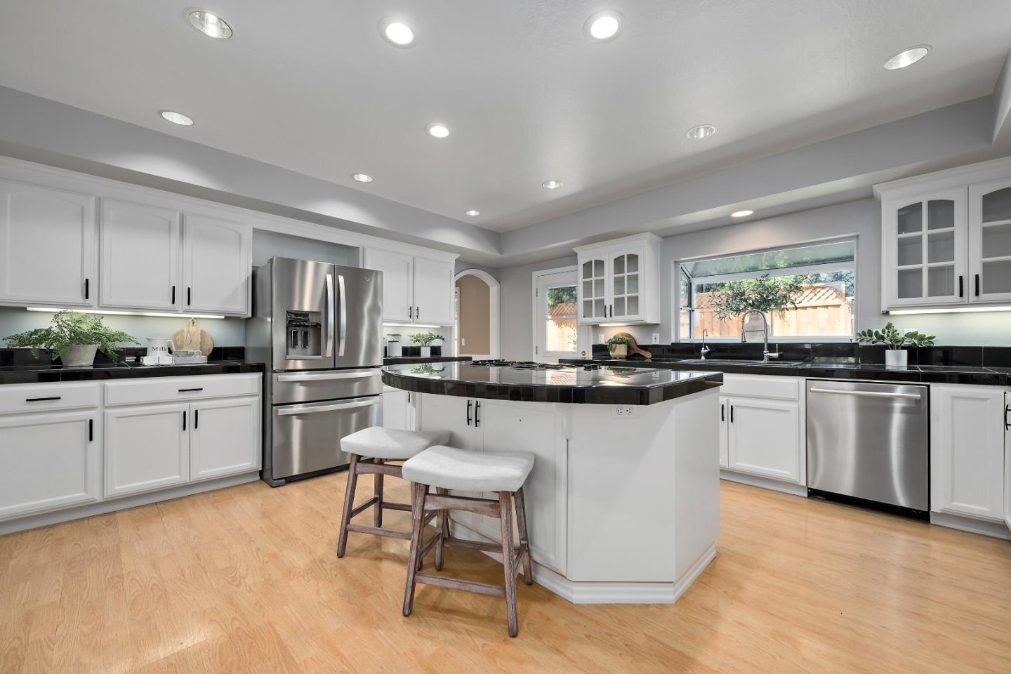 1629 Cherry Avenue San Jose, CA 95125 - Photo 21 of 61 a kitchen with stainless steel appliances kitchen island granite countertop a stove a sink a refrigerator and white cabinets