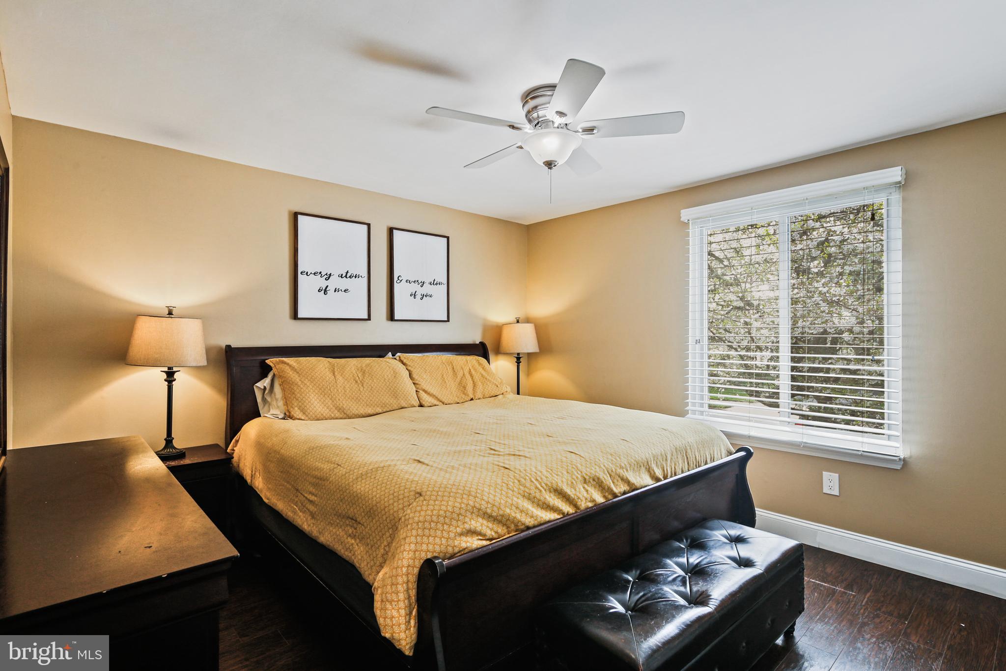 9348 Northgate Road Laurel, MD 20723 - Photo 14 of 42 a bed sitting in a bedroom next to a window