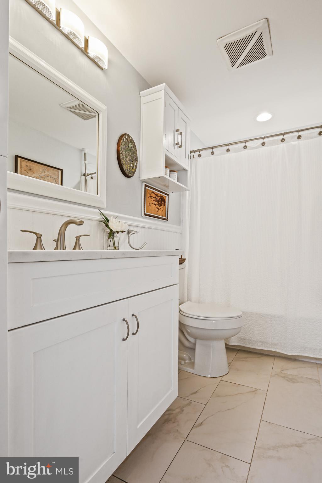 9348 Northgate Road Laurel, MD 20723 - Photo 18 of 42 a bathroom with a sink a toilet and a shower