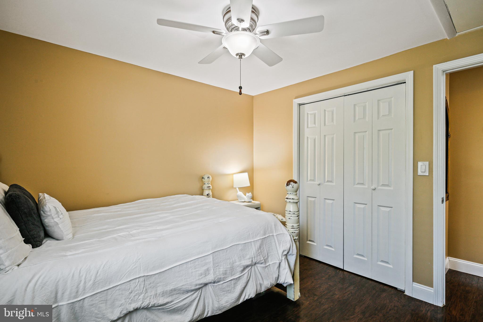 9348 Northgate Road Laurel, MD 20723 - Photo 20 of 42 a bedroom with a bed and a ceiling fan