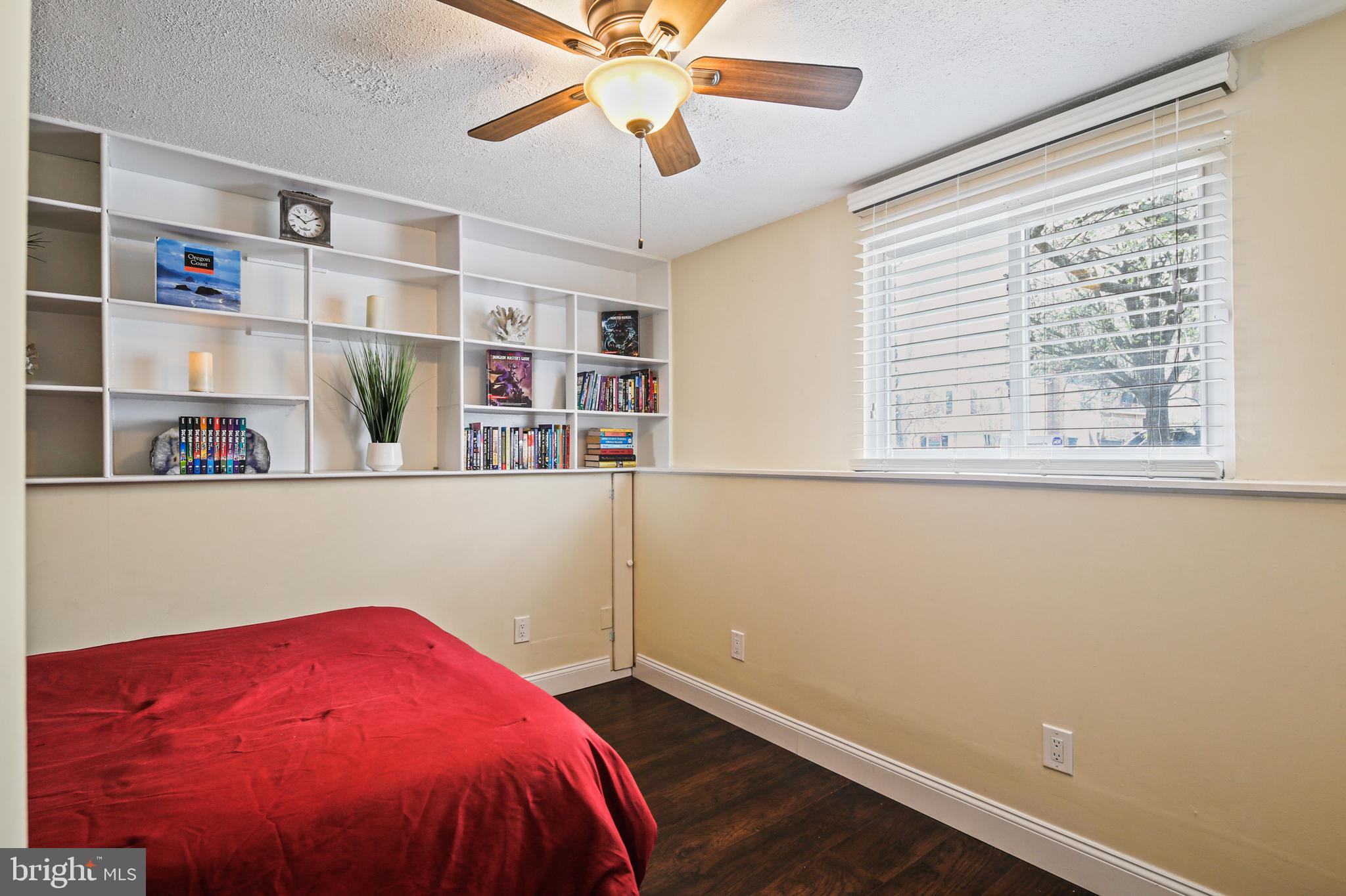 9348 Northgate Road Laurel, MD 20723 - Photo 22 of 42 a bed room with a bed and a book shelf