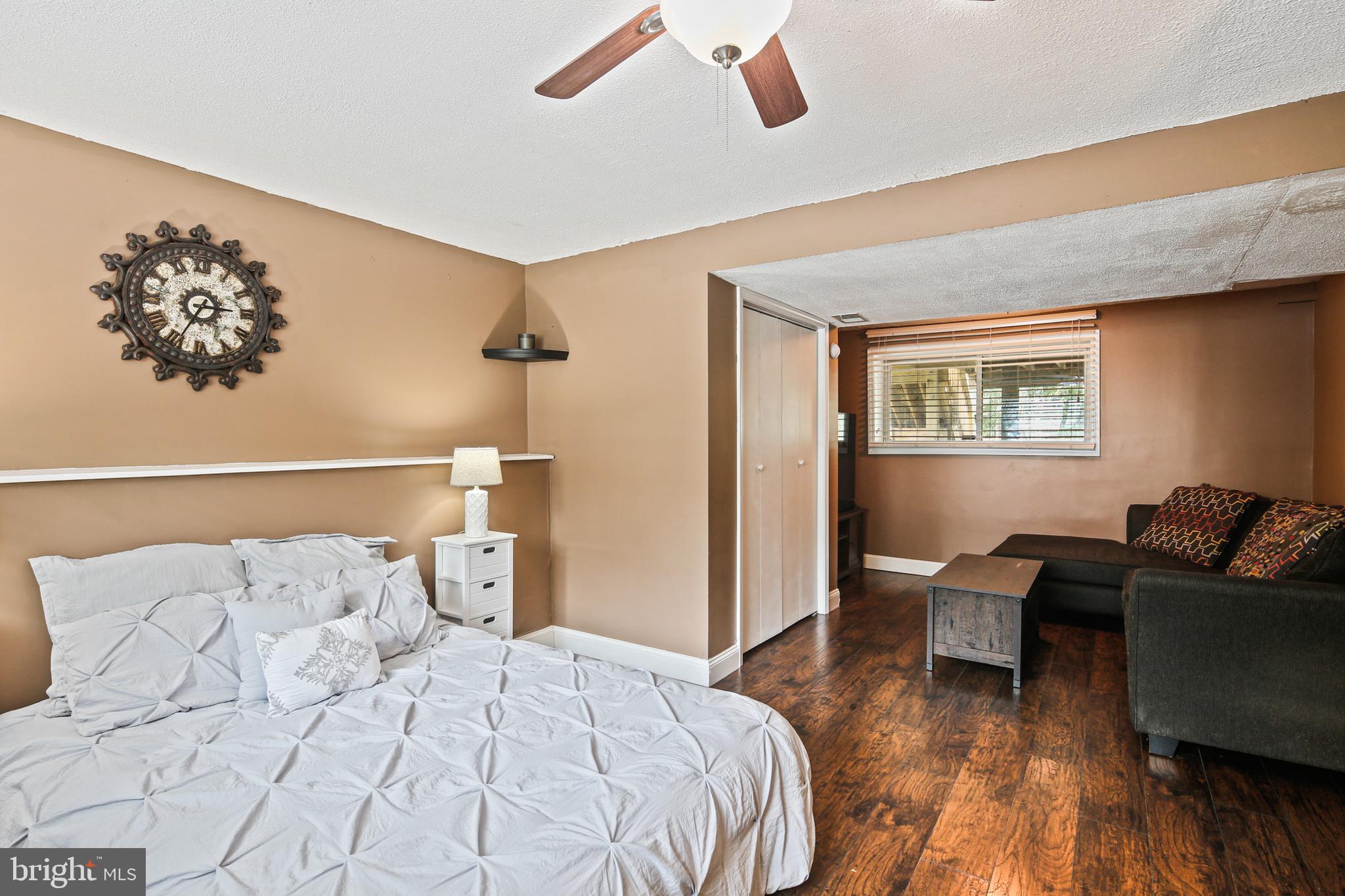9348 Northgate Road Laurel, MD 20723 - Photo 25 of 42 a bedroom with a bed and wooden floor