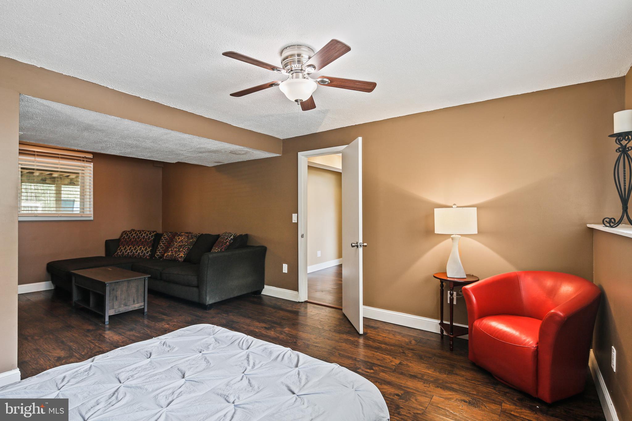 9348 Northgate Road Laurel, MD 20723 - Photo 26 of 42 a living room with furniture a ceiling fan and a rug