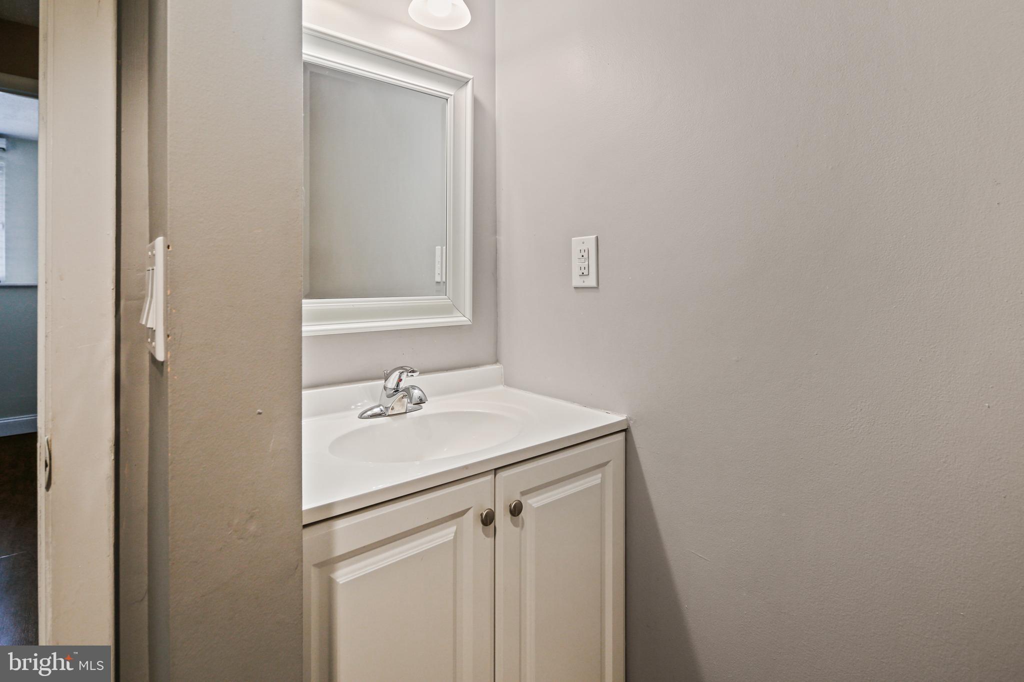 9348 Northgate Road Laurel, MD 20723 - Photo 33 of 42 a bathroom with a sink and vanity