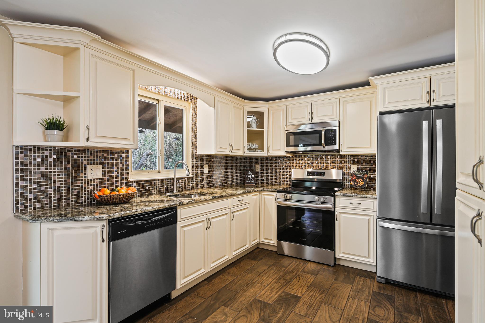 9348 Northgate Road Laurel, MD 20723 - Photo 6 of 42 a kitchen with a sink stainless steel appliances and white cabinets