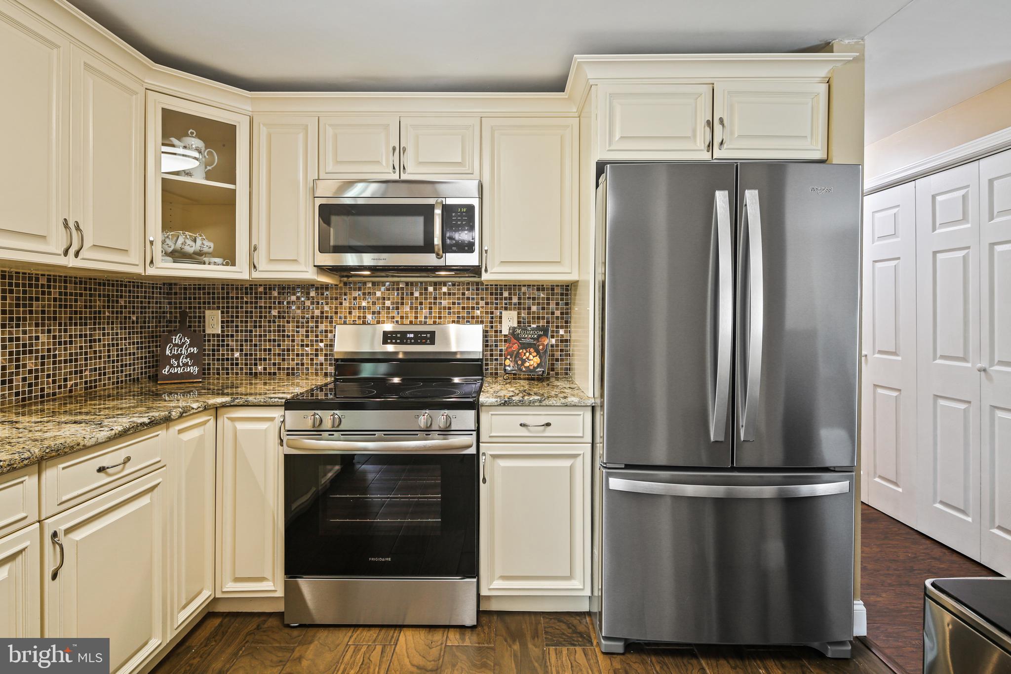 9348 Northgate Road Laurel, MD 20723 - Photo 9 of 42 a kitchen with stainless steel appliances a refrigerator stove and microwave