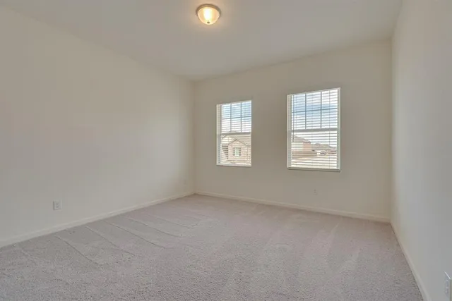 a kitchen with granite countertop a refrigerator a sink a stove a microwave and wooden floor