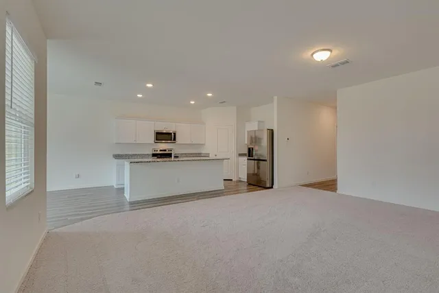 a view of kitchen with refrigerator sink and stove